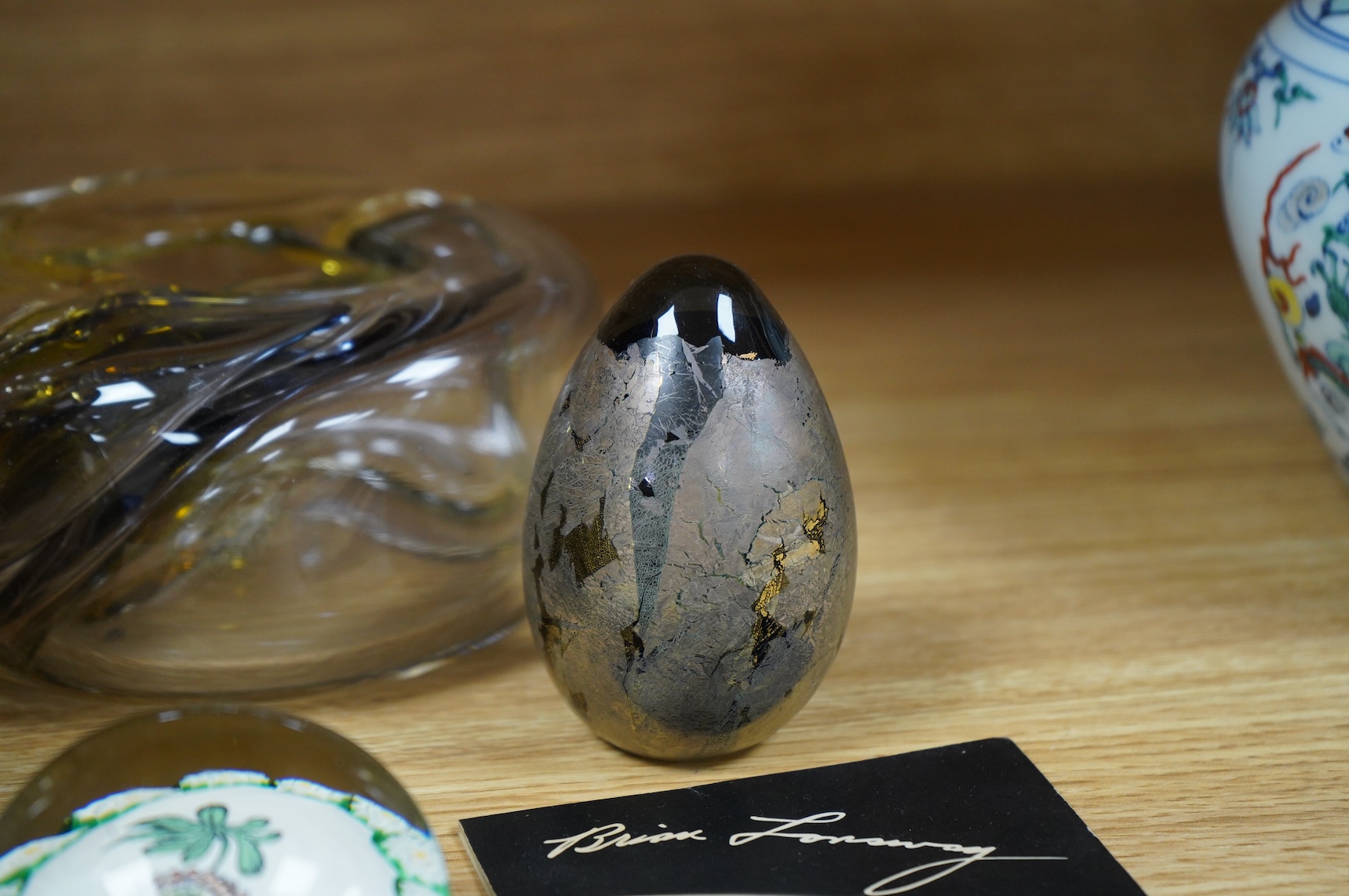 Brian Lonsway (American), an art glass ornamental dish, two Isle of Wight glass eggs and a floral paperweight, tallest 8.5cm